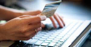 Photo of person using credit card to purchase something online